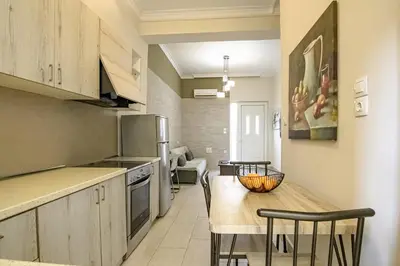 a kitchen with a table and chairs in a room at PLUS 2! in Chania Town