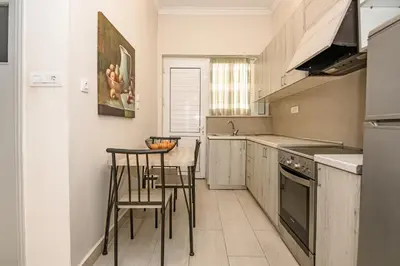 a kitchen with a table and chairs in it at PLUS 2! in Chania Town
