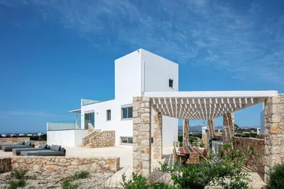 a white house with a stone wall at Vista Residence in Chania Town