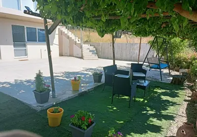 a yard with a table and chairs and potted plants at Amazing View in Kissamos