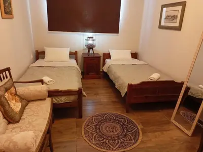 a room with two twin beds and a couch at Amazing View in Kissamos
