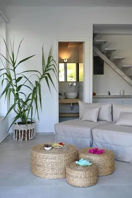 a living room with a couch and two ottoman at Annassa Experience Villa 2' walk from Almyrida beach in Almirida