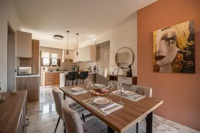 a dining room and kitchen with a table and chairs at Cretan Sea View Apt 8mins to beach,old town, city in Chania Town