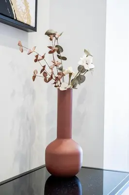 a vase with flowers in it sitting on a table at Yiannis Deluxe Apartment in Chania Town