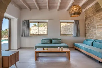 a living room with a couch and a table at Alma Natura Villas Falasarna- Avgerinos Villa in Falasarna