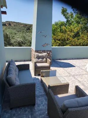 a patio with wicker chairs and couches at Anatolika Stamatis Paradise in Dhémbla