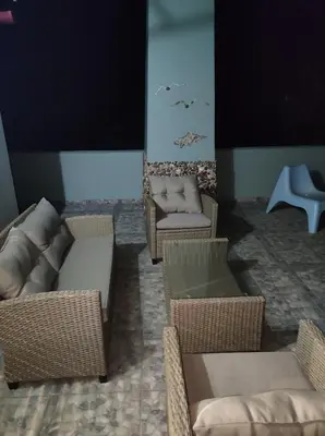 a living room with wicker chairs and couches at Anatolika Stamatis Paradise in Dhémbla