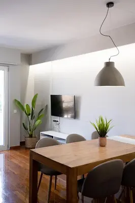 a dining room with a wooden table and chairs at Chania Central Apartment in Chania Town