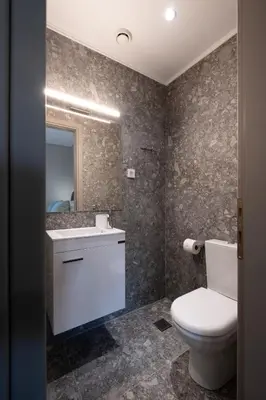 a bathroom with a toilet and a sink at Chania Central Apartment in Chania Town