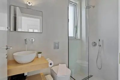 a bathroom with a sink and a shower at Annassa Experience Suites 2' walk from Almyrida Beach in Almirida