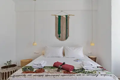a bedroom with a bed with towels on it at Annassa Experience Suites 2' walk from Almyrida Beach in Almirida