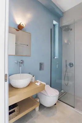 a bathroom with a sink and a toilet and a shower at Annassa Experience Suites 2' walk from Almyrida Beach in Almirida