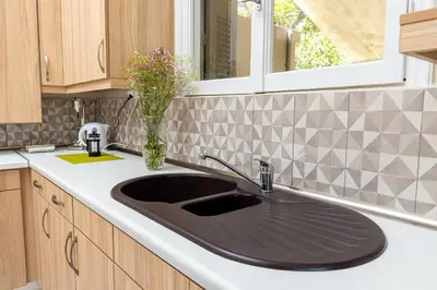 a kitchen with a sink and a window at Πλήρως ανακαινισμένη μονοκατοικία. in Chania Town