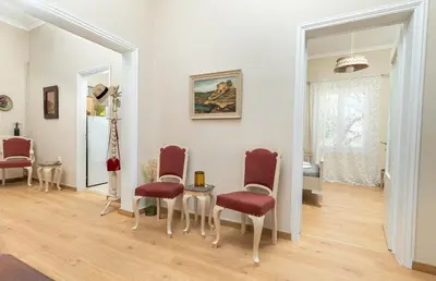 a room with chairs and a table and a mirror at Πλήρως ανακαινισμένη μονοκατοικία. in Chania Town
