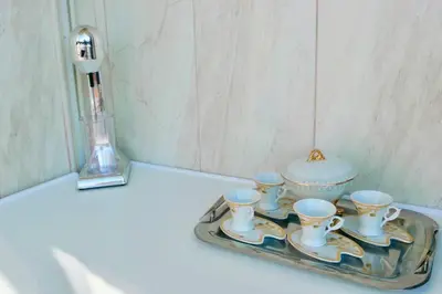 a tray with four cups and a tea set on it at Elpida Seafront Paradise apartment in Crete in Chania Town