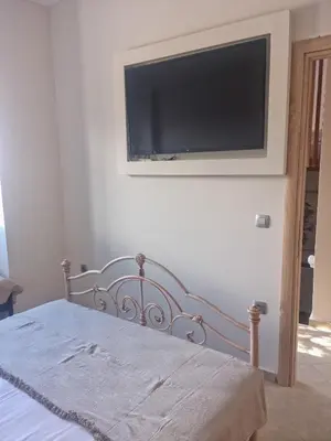 a bedroom with a bed with a television on the wall at Villa Vanessa in Kissamos