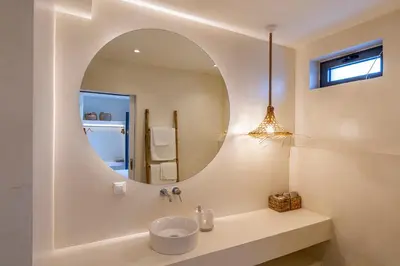 a bathroom with a sink and a mirror at Akra Grammeno Beachfront Villas in Palaiochóra