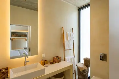 a bathroom with a sink and a mirror at Akra Grammeno Beachfront Villas in Palaiochóra