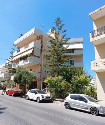 a row of cars parked in front of a building at Argy Cozy Apartment (Όμορφο Διαμέρισμα στα Χανιά) in Chania Town