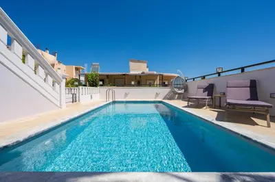 a swimming pool on the roof of a house at Sounds Of The Mountain Chania in Varípetron