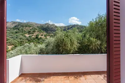 a balcony with a view of the mountains at Sounds Of The Mountain Chania in Varípetron