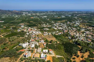 an aerial view of a small town with houses at Sounds Of The Mountain Chania in Varípetron