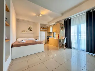 a large bedroom with a bed and a kitchen at Alendra's City Center Studio in Chania Town