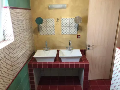 a bathroom with two sinks and a mirror at Pink House in Palaiochóra