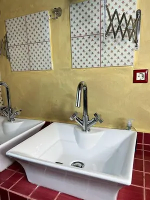 a sink with two faucets in a bathroom at Pink House in Palaiochóra