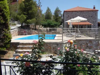 a house with a swimming pool and some flowers at Panorama Askifou in Karés