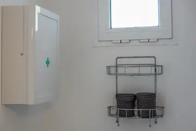 two baskets on a shelf next to a window at Elafonisi Vacation Green Studio in Agios Padeleimon