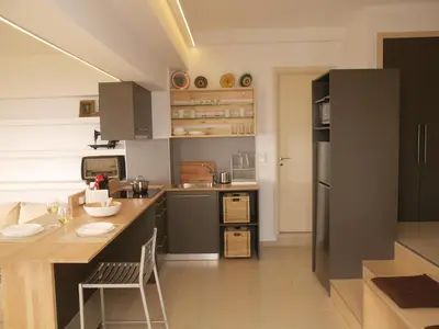 a kitchen with a counter and a table in it at The Garden of Zephyrus - East in Pithárion