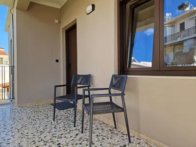 two chairs and a table in front of a window at Mosaic Apartments in Chania Town