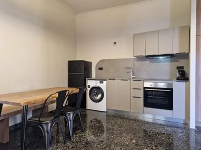 a kitchen with a table and chairs and a stove at Mosaic Apartments in Chania Town