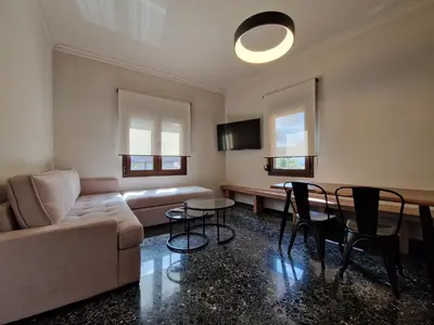 a living room with a couch and a table and chairs at Mosaic Apartments in Chania Town