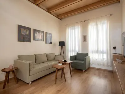 a living room with a couch and a chair at Austrinus house, luxury property for max. 5 persons in Chania Town