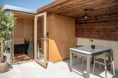 a dining room with a table and a wooden wall at Austrinus house, luxury property for max. 5 persons in Chania Town