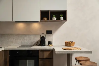 a kitchen with white cabinets and a counter top at KOEV slow living in Tsikalariá