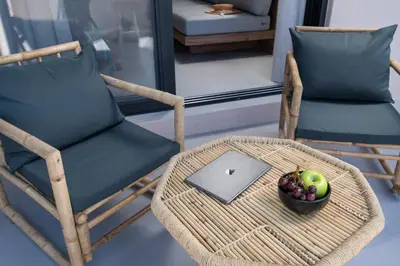 a wicker chair with a bowl of fruit and a laptop at KOEV slow living in Tsikalariá
