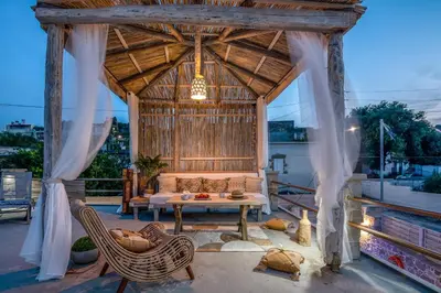 an outdoor living room with a couch and a table at Pool Villa Michail, in Kissamos! in Koukounará