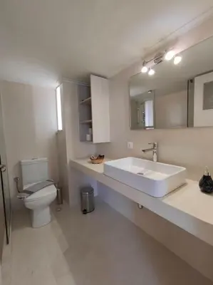 a bathroom with a sink and a toilet and a mirror at Chania-Limani Splantzia-geada in Chania Town