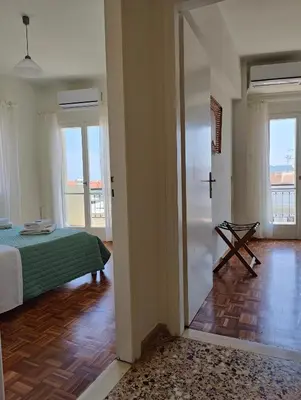 a bedroom with a bed and a door to a room at Chania-Limani Splantzia-geada in Chania Town