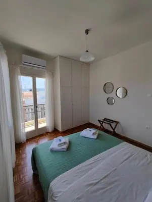 a bedroom with a bed with two towels on it at Chania-Limani Splantzia-geada in Chania Town