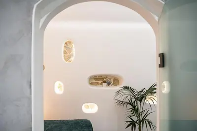 a living room with an archway and a plant at Malmáki, a street view apartment in Chania Town
