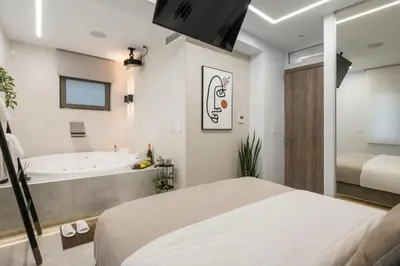 a bedroom with a bed and a bath tub at Pi Suite Project Smart Living in Chania Town