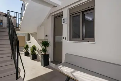 a balcony with a bench and potted plants at Pi Suite Project Smart Living in Chania Town