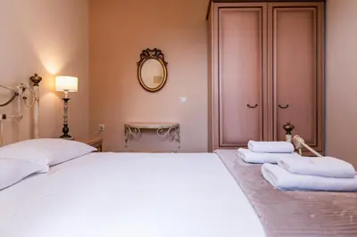 a bedroom with a white bed and a mirror at Giovanta Villa in Kondomari