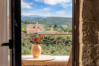 a vase with flowers sitting on a table in front of a window at Giovanta Villa in Kondomari