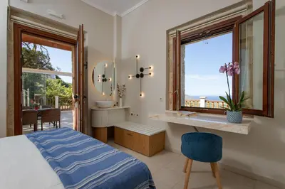 a bedroom with a bed and a window at Villas Libra in Falasarna