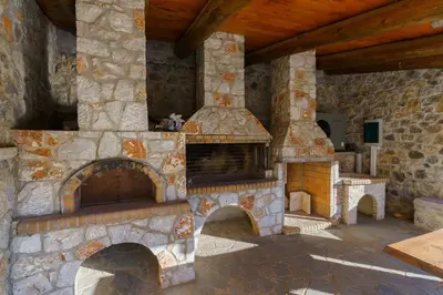 a large stone oven in a stone house at Omalos Village in Omalós